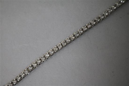 A modern 18ct white gold and diamond line bracelet. 17.5cm.